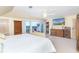 Bright bedroom with a sitting area, walkout access, and TV at 36 Seawatch Dr, Boca Grande, FL 33921