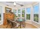 Bright dining area with large windows and a table for four, with a serene view of foliage at 36 Seawatch Dr, Boca Grande, FL 33921