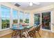 Bright dining area with large windows and a table for four, offering views of the water at 36 Seawatch Dr, Boca Grande, FL 33921