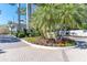 Landscaped entrance to the property, with lush tropical plants, flowers, and a decorative sign at 36 Seawatch Dr, Boca Grande, FL 33921