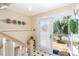 The entrance boasts tile flooring, a staircase, and access to the outdoor deck through a glass door at 36 Seawatch Dr, Boca Grande, FL 33921