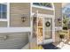 Inviting front entrance with a decorative glass door, exterior lamp, and a tile floor at 36 Seawatch Dr, Boca Grande, FL 33921