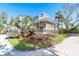 Corner lot home with mature landscaping, brick driveway, and a charming front porch at 36 Seawatch Dr, Boca Grande, FL 33921