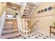 Foyer with curved staircase and interesting decor at 36 Seawatch Dr, Boca Grande, FL 33921