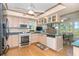 Open kitchen featuring stainless steel appliances and views from surrounding windows at 36 Seawatch Dr, Boca Grande, FL 33921