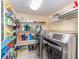 Efficient laundry area with ample shelving for storage and a modern washer/dryer set at 36 Seawatch Dr, Boca Grande, FL 33921