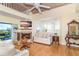 Cozy living room with fireplace, hardwood floors, bay window, and access to a balcony with water views at 36 Seawatch Dr, Boca Grande, FL 33921