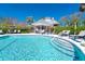 Inviting community pool with a clear view of the cabana and nearby lounge chairs at 36 Seawatch Dr, Boca Grande, FL 33921