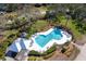 Aerial view of private pool and patio area surrounded by lush greenery and lounge chairs at 36 Seawatch Dr, Boca Grande, FL 33921