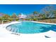 Beautiful community pool featuring clear blue water, a nearby cabana, and comfortable lounge chairs at 36 Seawatch Dr, Boca Grande, FL 33921