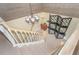 Carpeted staircase with white railings, leading to a landing with stylish decor at 36 Seawatch Dr, Boca Grande, FL 33921