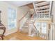 A winding staircase features wood treads, and a light colored carpet with views from the entry at 36 Seawatch Dr, Boca Grande, FL 33921