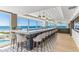 Modern bar with sleek countertops, stylish seating, and expansive windows offering stunning ocean views at 5000 Gasparilla Rd # Dc305, Boca Grande, FL 33921