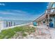 Picturesque backyard with direct waterfront access and a charming wooden staircase to the home at 5041 N Beach Rd # 1A And 1B, Englewood, FL 34223