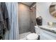 Modern bathroom features a tiled shower with a rainfall showerhead and decorative pebble flooring at 5041 N Beach Rd # 1A And 1B, Englewood, FL 34223