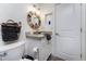 Bright bathroom with a wood-framed mirror, granite countertop, white cabinets, and neutral decor at 5041 N Beach Rd # 1A And 1B, Englewood, FL 34223