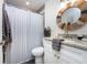 Stylist bathroom with shower-tub, decorative mirror, modern vanity with stone countertop, providing a clean and refreshing space at 5041 N Beach Rd # 1A And 1B, Englewood, FL 34223