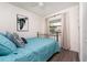 Comfortable bedroom with a large window, neutral walls, and a decorative art piece at 5041 N Beach Rd # 1A And 1B, Englewood, FL 34223