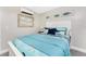 Bright bedroom featuring unique fish-themed decor and a comfortable queen-sized bed with a blue comforter at 5041 N Beach Rd # 1A And 1B, Englewood, FL 34223