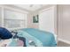 Bright bedroom enhanced by a window, showcasing coordinated bedding and a ceiling fan at 5041 N Beach Rd # 1A And 1B, Englewood, FL 34223