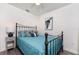 Cozy bedroom with a decorative metal frame bed, a ceiling fan and stylish furnishings at 5041 N Beach Rd # 1A And 1B, Englewood, FL 34223