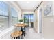Cozy dining area featuring a round wooden table, stools, and sliding glass doors to the outside at 5041 N Beach Rd # 1A And 1B, Englewood, FL 34223