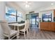 Charming kitchen and dining area with beautiful water views through sliding glass doors, creating an inviting space to dine and entertain at 5041 N Beach Rd # 1A And 1B, Englewood, FL 34223