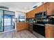 The kitchen offers natural cabinets, stainless appliances, and a seamless transition to a covered outdoor space with water views at 5041 N Beach Rd # 1A And 1B, Englewood, FL 34223