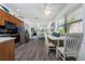 Open-concept kitchen and dining area with stainless steel appliances and abundant natural light, perfect for entertaining and daily living at 5041 N Beach Rd # 1A And 1B, Englewood, FL 34223
