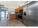 Well-equipped kitchen featuring stainless steel appliances, wood cabinets, and seamless access to outdoor space, blending indoor-outdoor living at 5041 N Beach Rd # 1A And 1B, Englewood, FL 34223