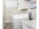 Functional laundry room equipped with modern washer, dryer, and storage solutions for convenience at 5041 N Beach Rd # 1A And 1B, Englewood, FL 34223
