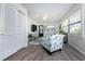Inviting living room featuring wood floors, natural light, and charming décor. A coastal designed chair and white cabinets add appeal at 5041 N Beach Rd # 1A And 1B, Englewood, FL 34223