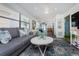Open-concept living room with a comfortable sofa, stylish decor, and seamless flow to the dining area at 5041 N Beach Rd # 1A And 1B, Englewood, FL 34223