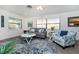 Cozy living room featuring large windows, comfortable seating, and stylish coastal-themed decor at 5041 N Beach Rd # 1A And 1B, Englewood, FL 34223