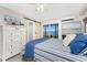 Stylish main bedroom featuring waterfront view, slider access, coastal decor, and a sliding barn door to bathroom at 5041 N Beach Rd # 1A And 1B, Englewood, FL 34223
