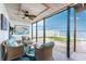 Charming screened porch with cozy seating and picturesque waterfront views at 5041 N Beach Rd # 1A And 1B, Englewood, FL 34223
