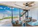 Relaxing screened porch featuring outdoor seating and scenic views of the waterfront at 5041 N Beach Rd # 1A And 1B, Englewood, FL 34223