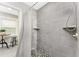 Modern walk-in shower with sleek gray tiles, integrated shelving, and stylish fixtures at 5041 N Beach Rd # 1A And 1B, Englewood, FL 34223