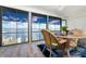 Sunroom with water views, wicker table setting and blue area rug at 5041 N Beach Rd # 1A And 1B, Englewood, FL 34223