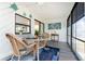 Bright sunroom with water view, coastal decor, wicker furniture, and large windows at 5041 N Beach Rd # 1A And 1B, Englewood, FL 34223