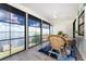 Light-filled sunroom with a lake view, stylish furniture, and a ceiling fan at 5041 N Beach Rd # 1A And 1B, Englewood, FL 34223