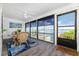 Enclosed patio with full views of the lake, a ceiling fan and comfortable dining set at 5041 N Beach Rd # 1A And 1B, Englewood, FL 34223