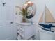 Bathroom with white vanity, mirror, and nautical decor with easy access to towels and toiletries at 5041 N Beach Rd # 3A And 3B, Englewood, FL 34223