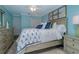 Comfortable bedroom with blue walls, closet, dresser, and comfortable furniture at 5041 N Beach Rd # 3A And 3B, Englewood, FL 34223