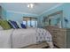 Beautiful bedroom with aqua walls, a dresser with decor, and windows with waterfront views at 5041 N Beach Rd # 3A And 3B, Englewood, FL 34223