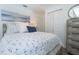 Bedroom with nautical decor, large closet, and well lit with lamp and overhead lighting at 5041 N Beach Rd # 3A And 3B, Englewood, FL 34223