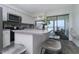 Inviting kitchen featuring stainless steel appliances, an island with seating, and an open view to the balcony at 5041 N Beach Rd # 3A And 3B, Englewood, FL 34223