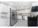Open kitchen with stainless steel appliances and spacious refrigerator at 5041 N Beach Rd # 3A And 3B, Englewood, FL 34223