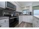 Updated kitchen featuring stainless steel appliances, neutral countertops and ample storage space at 5041 N Beach Rd # 3A And 3B, Englewood, FL 34223