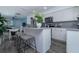 Well-lit kitchen boasting white cabinets, stainless steel appliances, and a cozy breakfast bar with seating at 5041 N Beach Rd # 3A And 3B, Englewood, FL 34223